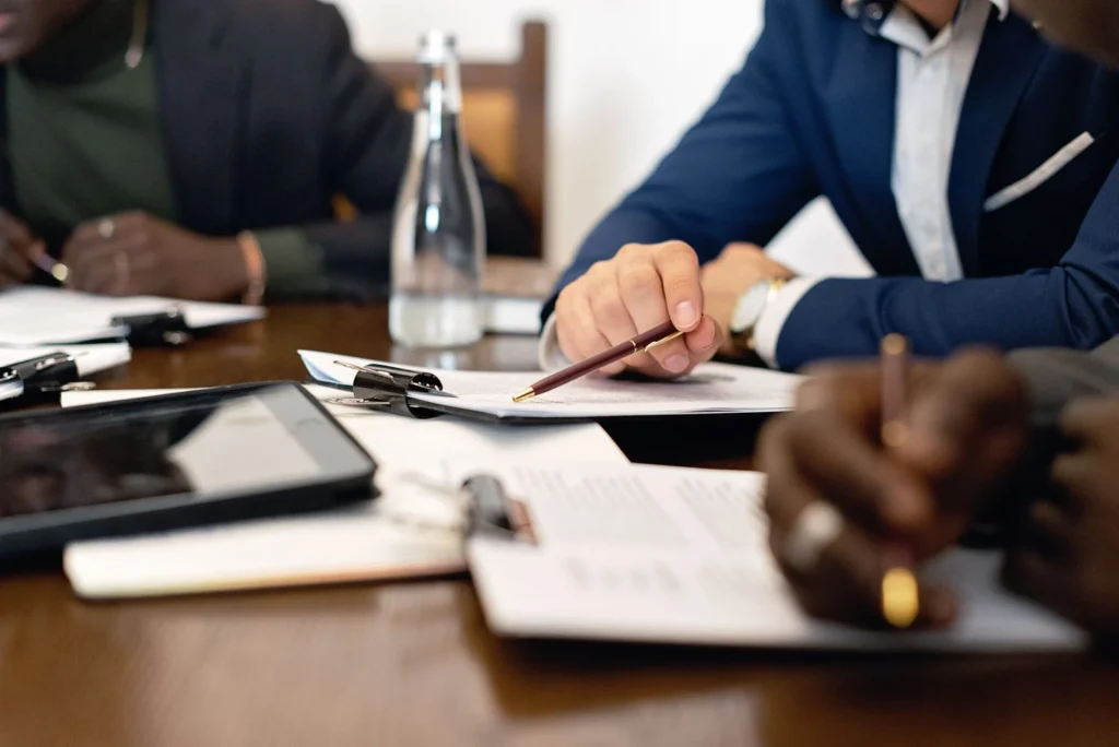 Professionals reviewing a paper document at a table