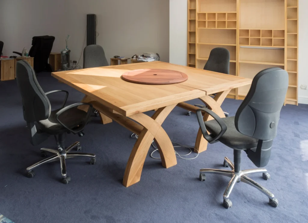 Empty modern meeting room with a wooden table and chairs.