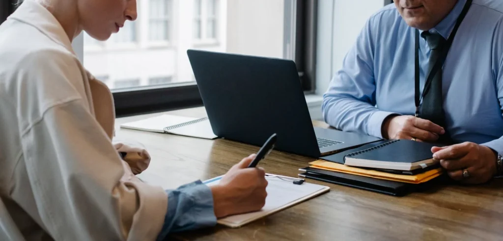 Two professionals reviewing a document at a table