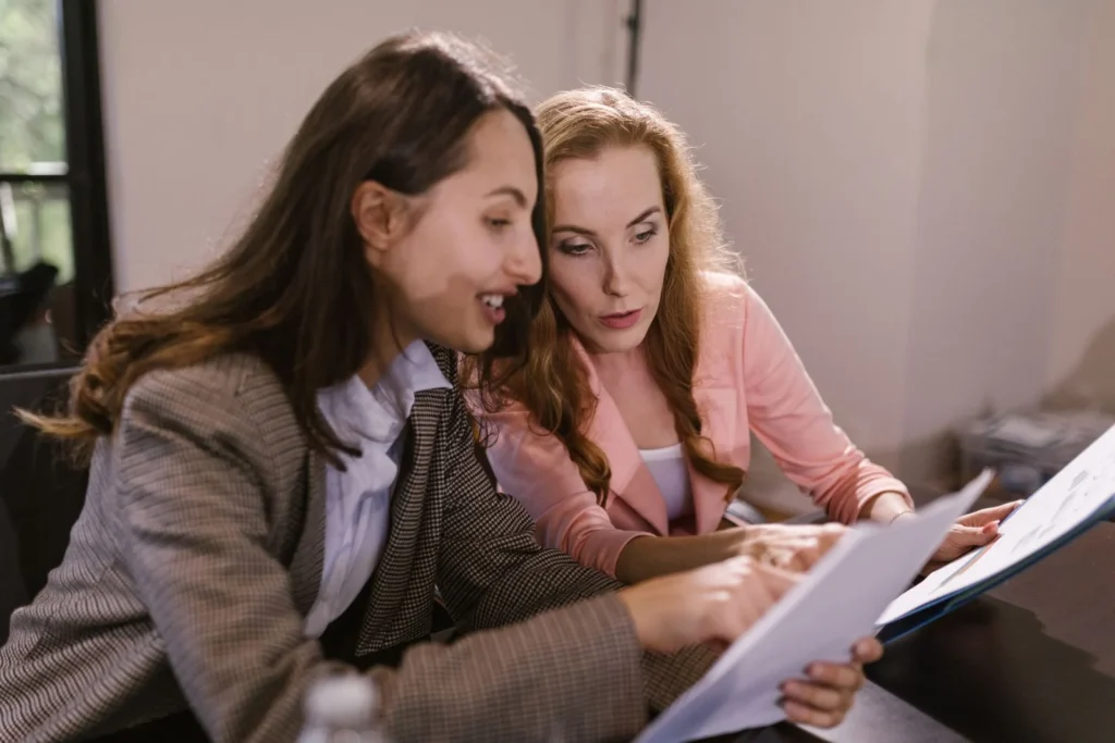 Two professionals reviewing a document together