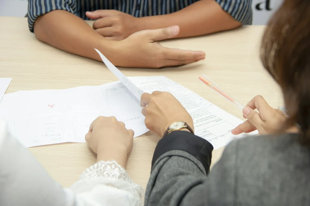 Two people reviewing documents together at a table.